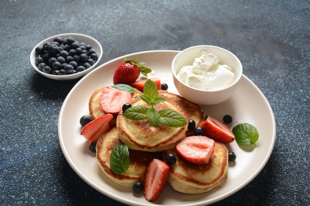 Sweet pancakes wrapped with fresh blueberries  mint strawberries