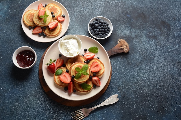 Sweet pancakes wrapped with fresh blueberries  mint strawberries