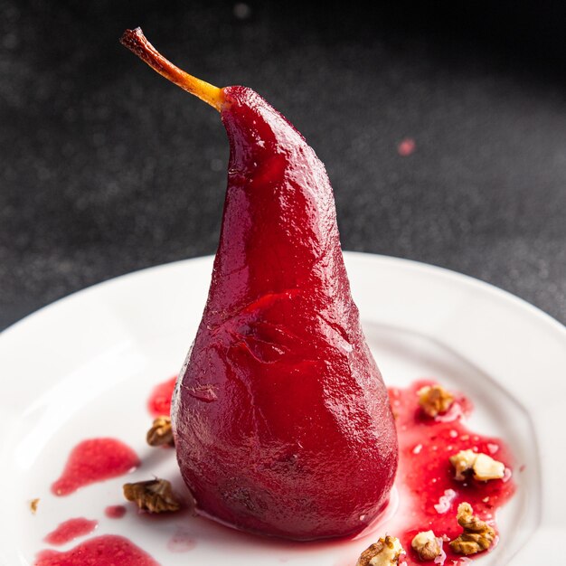 sweet pear in red wine dessert french cuisine healthy meal food snack diet on the table copy space