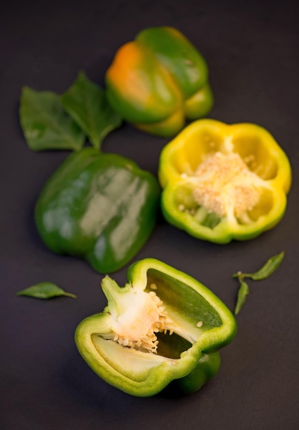 Sweet pepper green bell pepper on black background full depth of field