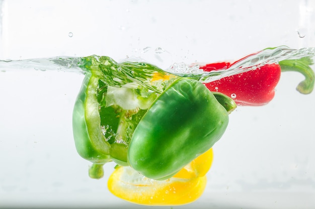 Sweet pepper in the yellow, red, green splashes of water, Sweet pepper on white