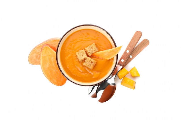 Sweet potato cream soup isolated on white