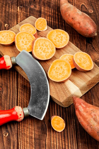 Sweet potatoes on wooden surface