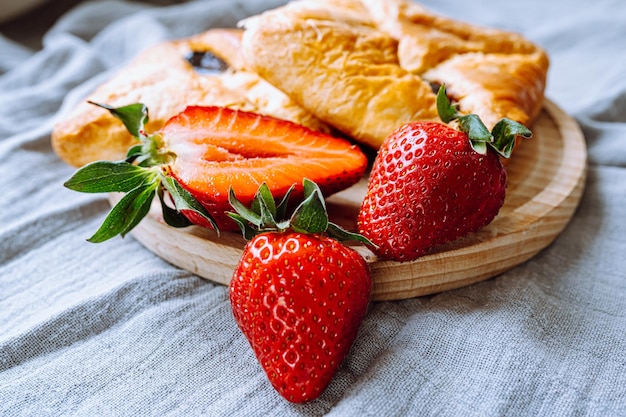 Sweet puff pastry with strawberry jam. Close-up summer dessert sweet envelopes with jam