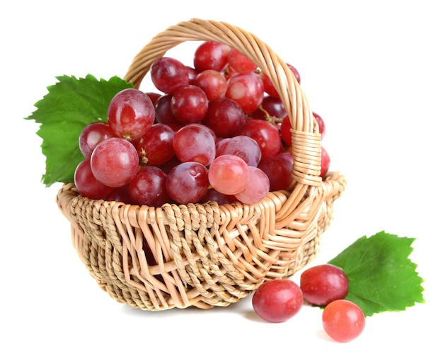 Sweet red grapes in wicker basket isolated on white