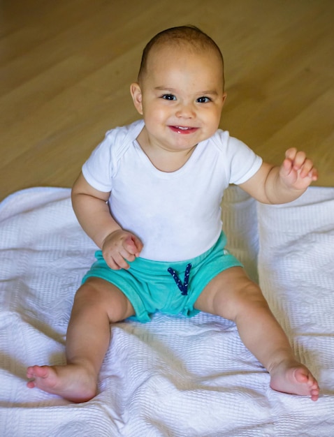 Sweet smiling baby on the floor Baby boy at home