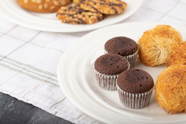 Sweet snacks placed on a stone table .