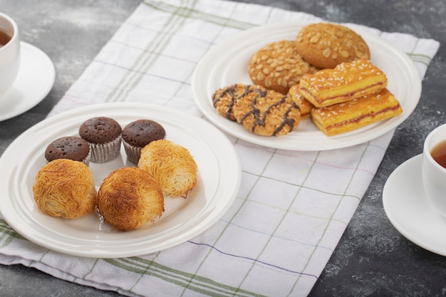 Sweet snacks placed on a stone table .