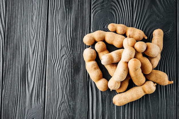 sweet and sour tamarind on a black rustic wooden background