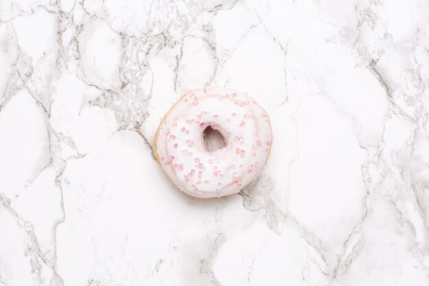 Sweet strawberry donut on marble surface isolated flat lay, minimalism, food