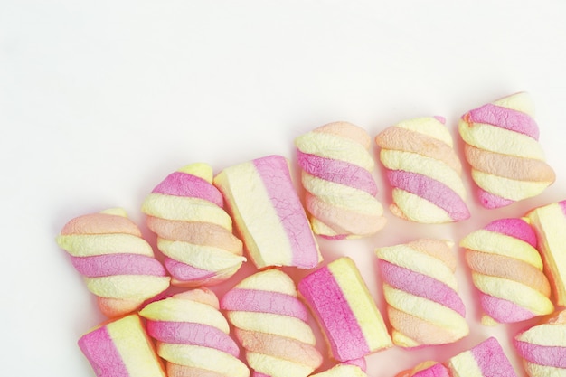 Sweet striped pink and yellow marshmallows on white