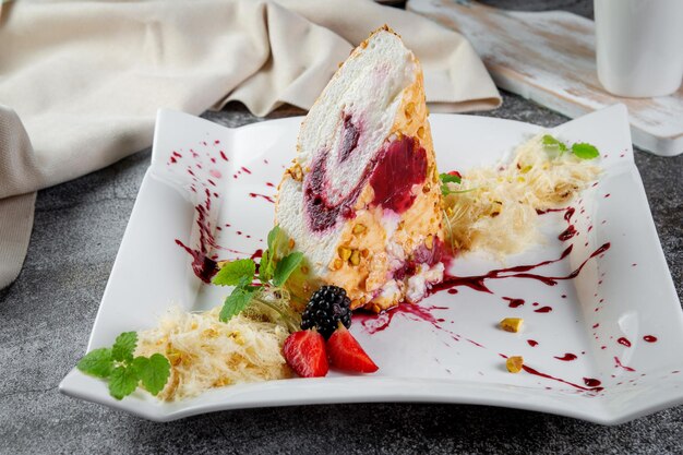 Sweet summer dessert made of eggs sugar berry puree and seasonal berries with cheese cream and powdered sugar