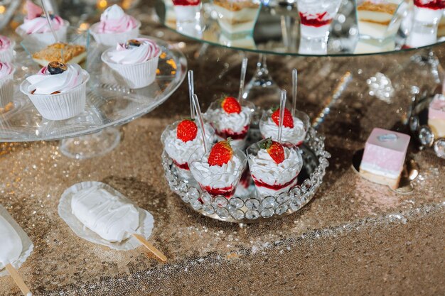 A sweet table at a wedding Table with cakes and sweets at the festival Birthday sweets