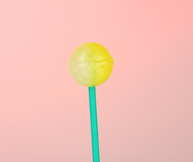 Sweet and tasty lollipop on pink background closeup