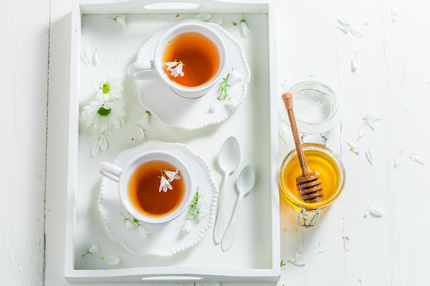 Sweet tea with honey in sunny summer day