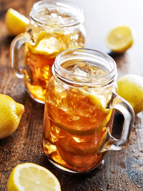 Sweet tea with lemon and ice in jars