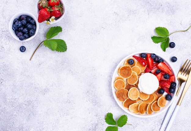 Sweet tiny pancake cereals with berries