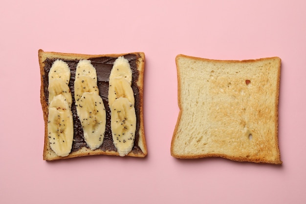 Sweet toast with banana on pink background