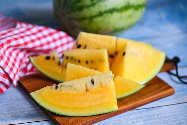 Sweet watermelon slices pieces fresh watermelon tropical summer fruit Yellow watermelon slice on wooden background