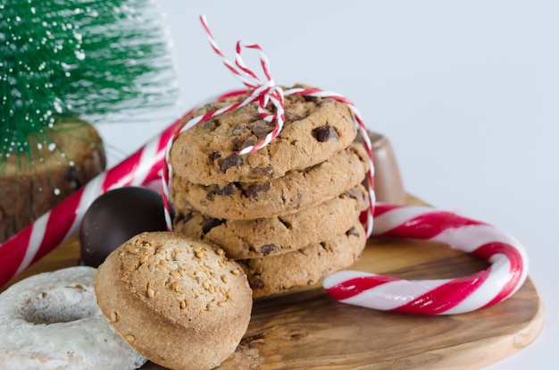 Sweets with Christmas decorations and olive wood kitchen table.