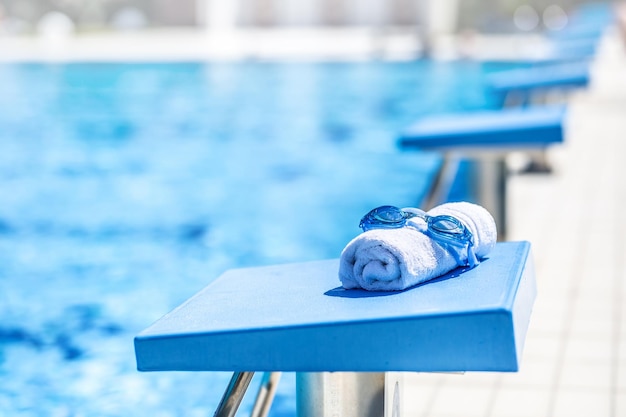 Swimming goggles with a towel ready for sports swimming in the pool