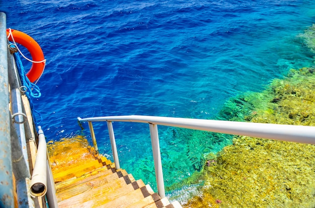 Swimming ladder with a pontoon in the warm sea