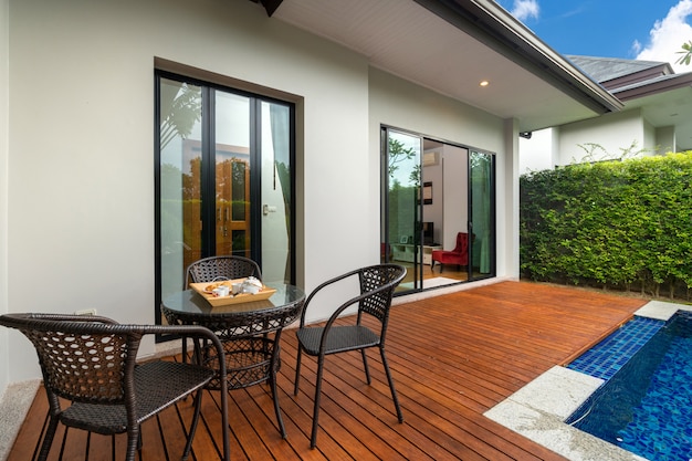 Swimming pool and decking in garden of luxury home