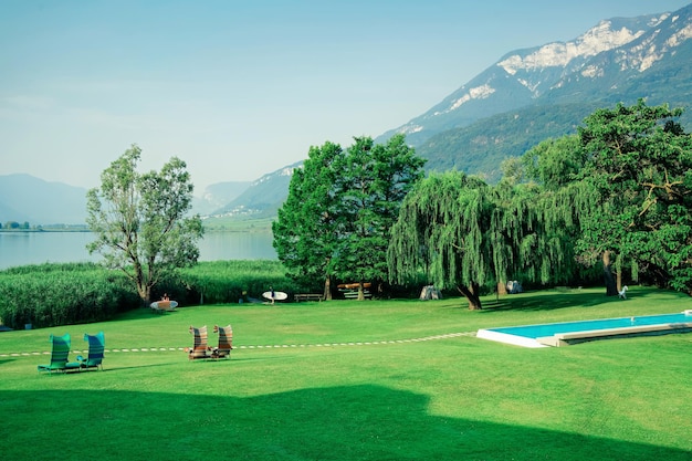 Swimming pool and nature. Beautiful summer vacation with landscape background. Travel and Fun holiday. Hotel or villa outdoor in Italian resort at Caldaro Lake in South Tyrol. Lifestyle. Mixed media.