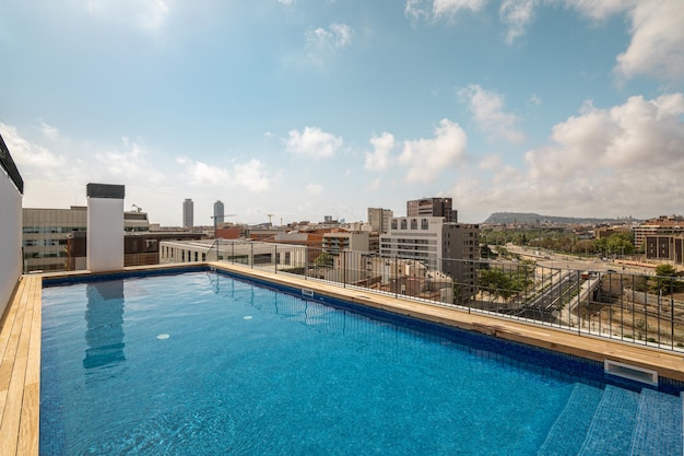 Swimming pool on roof top with beautiful city view on sunny day in Barcelona, Spain