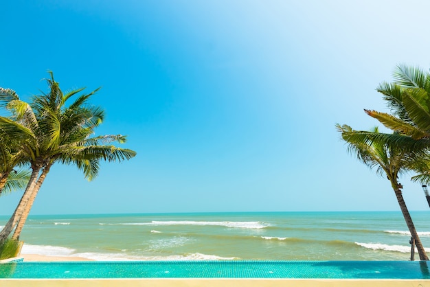 swimming pool and tropical beach for relaxation in summer