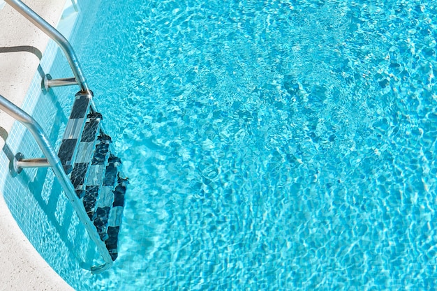 Swimming pool with blue water at summer vacation