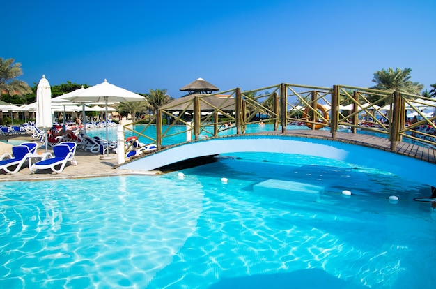 Swimming pool with coconut tree and umbrella