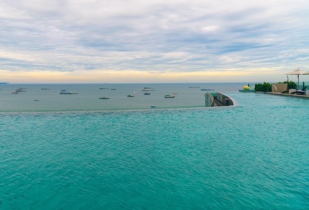 Swimming pool with ocean sea and boat background