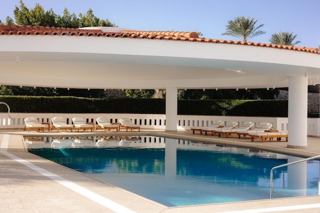 A swimming pool with a roof that says'marbella'on it