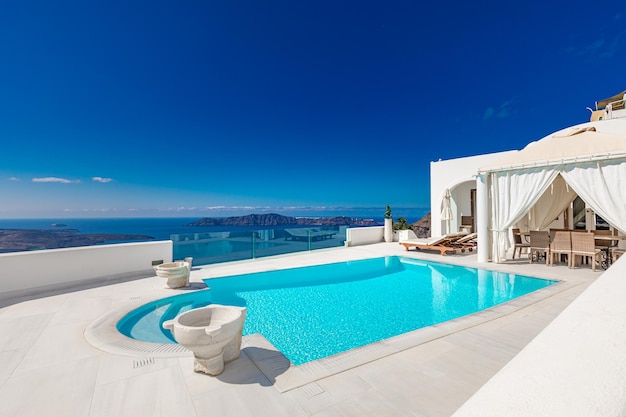 Swimming pool with sea view on Caldera over Aegean sea Santorini Greece Honeymoon destination