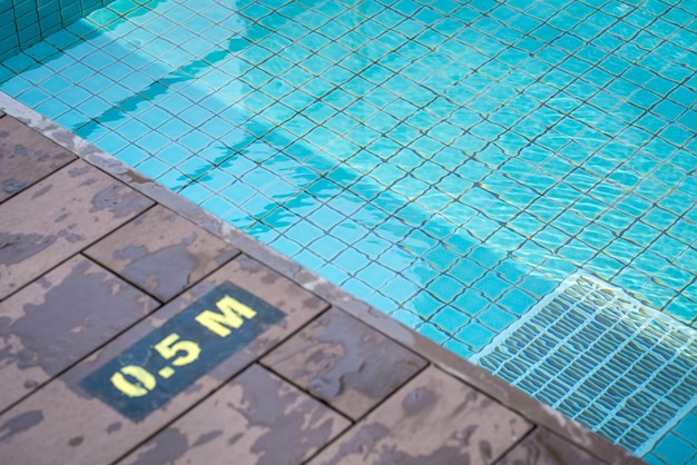 Swimming pool with sign of 05m on the floor tiles