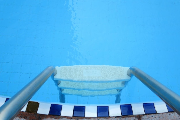 Swimming pool with stair swim is good sport for exercise Selective focus Sport and outdoor concept