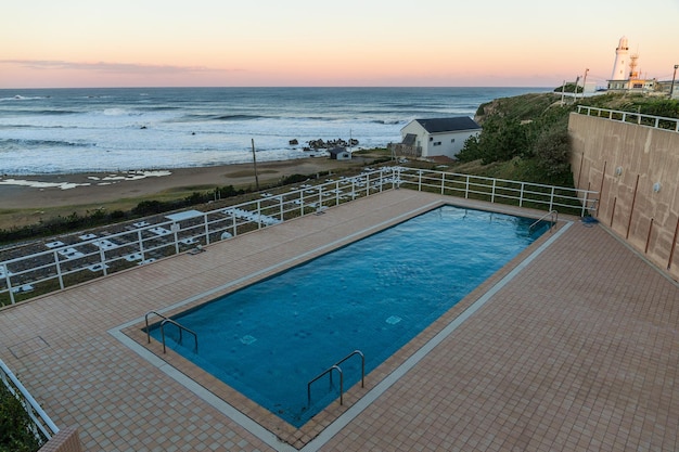 Swimming pool with sunset sea view