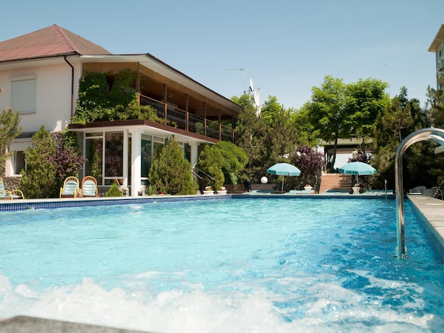 Swimming pool with tables for leisure travelers at the hotel