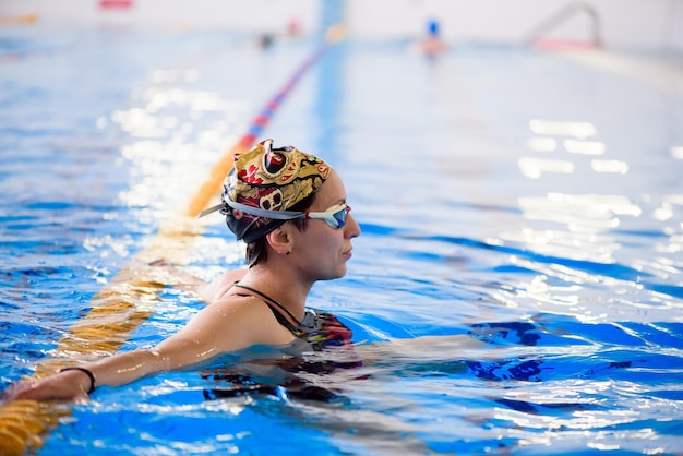 Swimming workout in the sports pool The coach shows a swimming master class