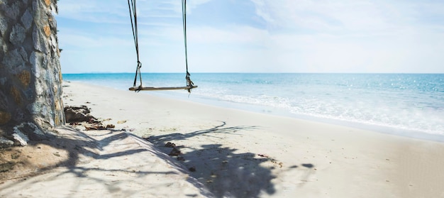 The Swings no people on a scenic beach in a Thailand tropical sea at summer season with a calm waves and blue sky for relaxation in holiday