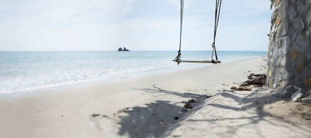 Swings on scenic beach in tropical sea at summer season 