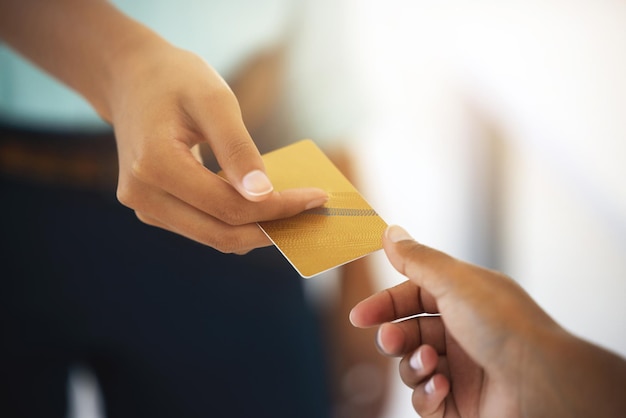 Swiping while I shop Cropped shot of an unrecognizable person giving someone a credit card