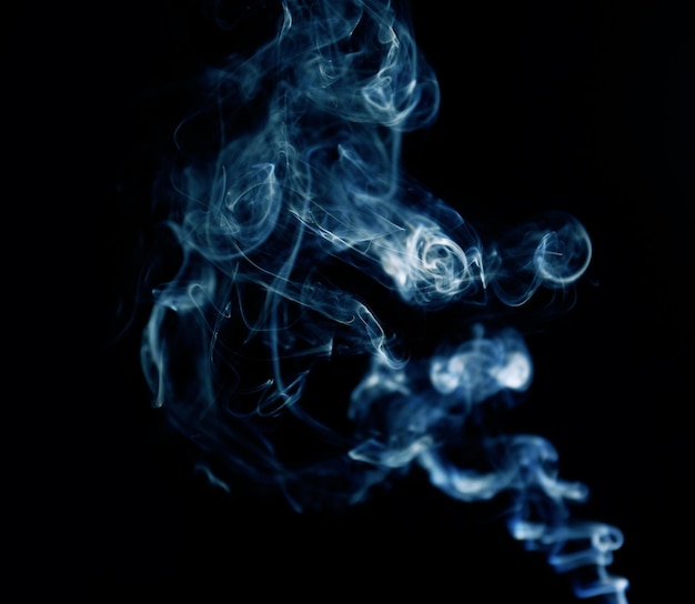 Swirl of white smoke on black background