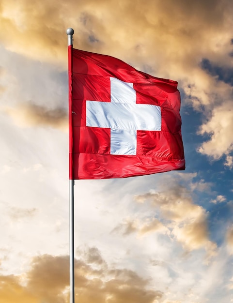 Swiss flag waving against sunset sky