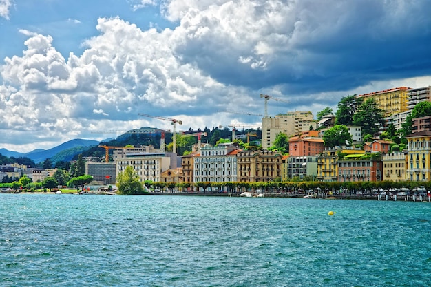 Swiss houses at Lake Lugano and mountains in Lugano of Ticino canton of Switzerland.