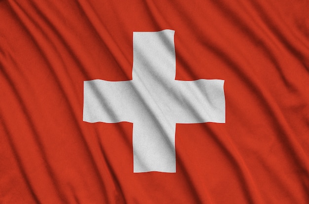 Switzerland flag  is depicted on a sports cloth fabric with many folds.