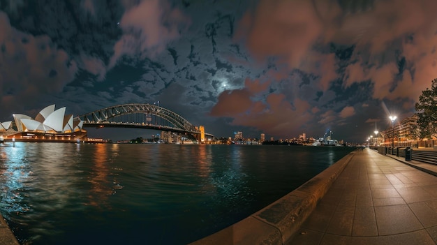 Photo sydney cityscape riverbank scene with sydney harbor bridge beside sydney opera house at dusk with blue sky