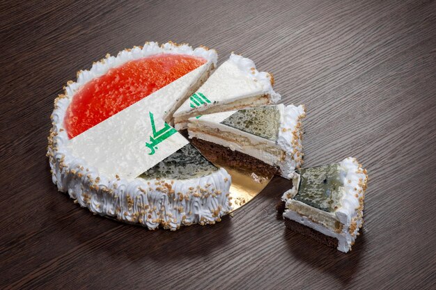 The symbol of war and separatism a cake with a picture of the flag of Iraq is broken into pieces