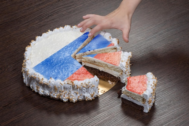 The symbol of war and separatism a cake with a picture of the flag of Russia is broken into pieces